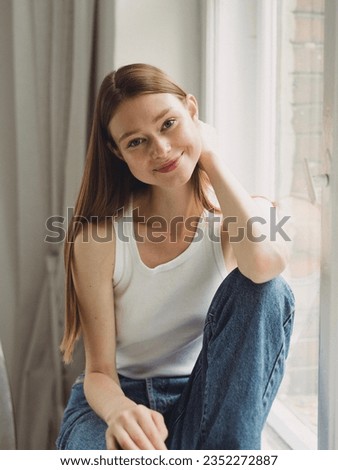 Photo shoot girl model style fashion portrait smile young woman lady white black lifestyle studio shooting beautiful Caucasian happy cute beauty casual sitting jeans posing hands face eyes tenderness