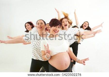 Photo shoot of a pregnant young woman with her best friends