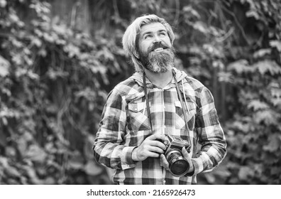 photo shooting outdoor. brutal man traveler with retro camera. photography in modern life. travel tips. professional photographer use vintage camera. bearded man hipster take photo. idyllic vacation