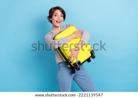 Photo of short hairdo young lady hold bag wear shirt jeans isolated on blue color background