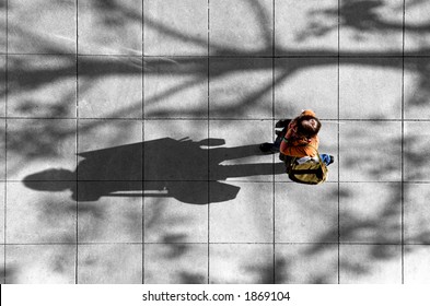 Photo Shot From Above Of A Woman Walking Along A City Street.