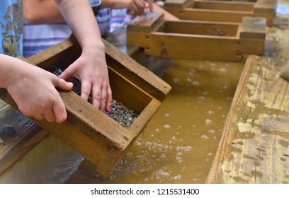 A Photo Showing A Child's Hand Using A Gold Sifter Panning For Gold And Gems A Great Educational Outdoor Acitivity With Kids