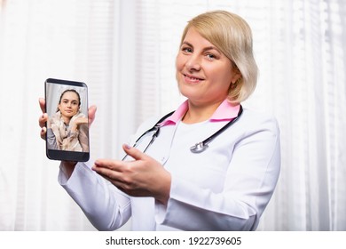 Photo Showing Online Doctor Working At Laptop In Medical Office. Distance Job. Business Photo, Modern Healthcare Practitioners, Deliver Medical Services Over The Internet. High Quality Photo