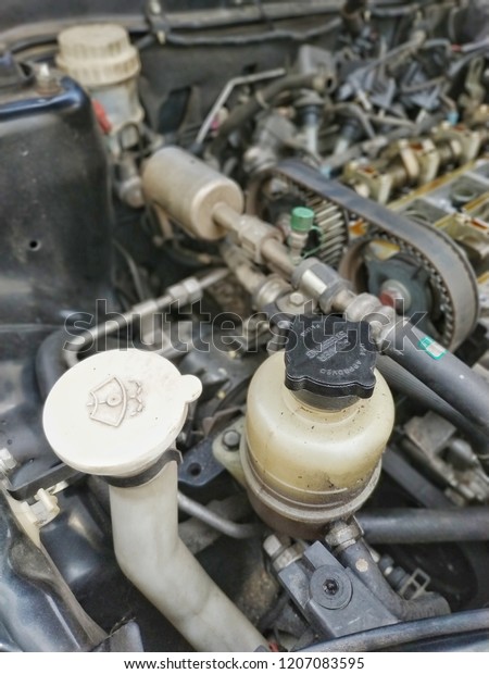 Photo showing power steering fluid tank and\
wiper water reservoir in the car\
engine.