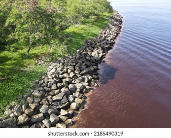 The Photo Showing Is A Rocky Breakwater Structure At The Seaside Which Is Infrastructure Built To Break Waves Or Waves By Absorbing Some Of The Wave Energy.