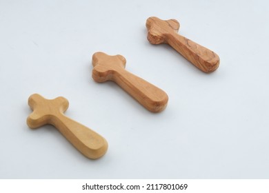 A photo showing three wooden cross arranged on a white background