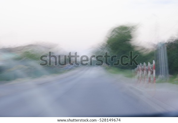 Photo shows a blurred vision while driving after\
drinking alcohol. Focus on the photo used to show how you can see\
the influence of alcohol.