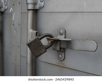 Photo shows a cargo van's back door being padlocked.