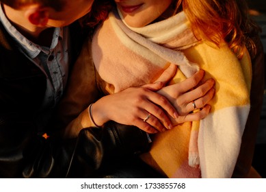 The photo shows the hands of a man and a woman. They hold each other. On their ring fingers are wearing wedding rings. Detailed photo. Photo taken with selective focus. The processing uses additional  - Shutterstock ID 1733855768