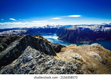 the photo shows the landscape of Norwegian mountains above the fjord