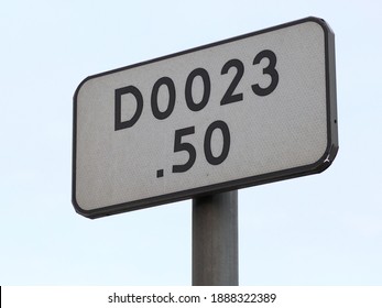 Photo Shows A Road Sigh Showing A Set Of Numbers And A Letter D.