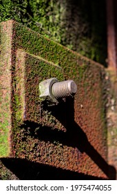 The Photo Shows A Rusted Steel Bracket With A Screw