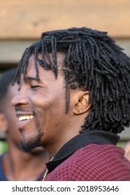 Photo From The Side. Portrait Of A Middle-aged African Man With A Traditional Hairstyle. Representative Of The Negroid Race, Originally From Cameroon. 