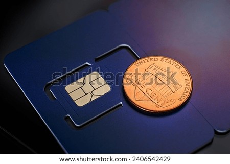 Photo of a SIM card with a one cent coin on it, close-up view