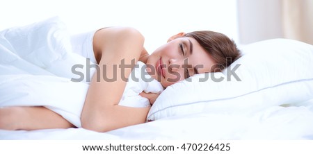 Photo of sleeping young woman lying in bed with eyes closed. Attractive beautiful bedroom bedtime caucasian closed comfort comfortable morning pajamas pillow relax rest sleep wellness white young