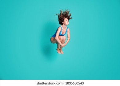 Photo of slim thin slender girl rest relax resort jump springboard dive water pool hold breath, hands legs wear blue bodysuit isolated over turquoise color background