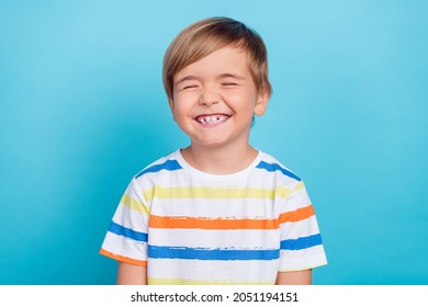 Photo of small funny blond boy wear white t-shirt isolated on blue color background - Shutterstock ID 2051194151