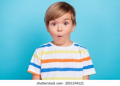 Photo of small impressed blond boy wear white t-shirt isolated on blue color background - Shutterstock ID 2051194121