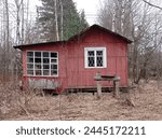 photo of a small red wooden house