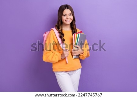 Photo of smart clever cheerful girl toothy smile hold book diary isolated on violet color background