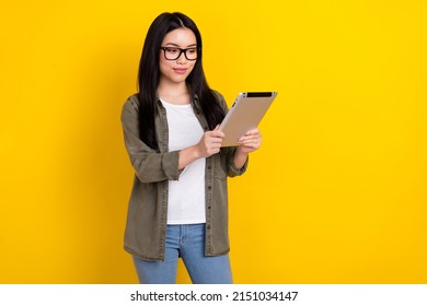 Photo Of Smart Intelligent Businesswoman Reading Important Document Use Digital Device Isolated On Yellow Color Background