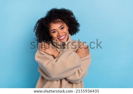 Photo of smiling lady cuddle herself enjoy cozy textile garment not from killed animals isolated blue color background