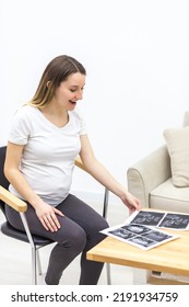 Photo Of Smiling Pregnant Woman With Ultrasound Result.