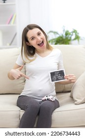 Photo Of Smiling Pregnant Woman With Ultrasound Result.