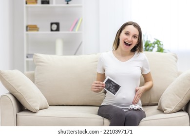 Photo Of Smiling Pregnant Woman With Ultrasound Result.