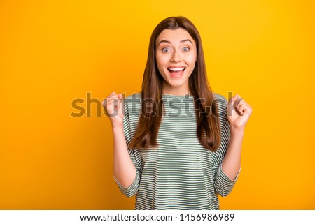 Photo of smiling shouting cheerful positive girlfriend having found dress she has wanted to obtain got cheaper by half while isolated with yellow background