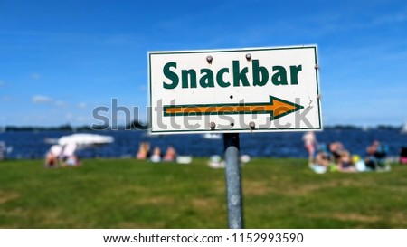 Photo of snackbar sign with arrow pointing to fast food restaurant
