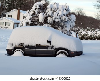 Photo Of A Snow Covered Vehicle In Home Driveway After A Winter Snow Blizzard