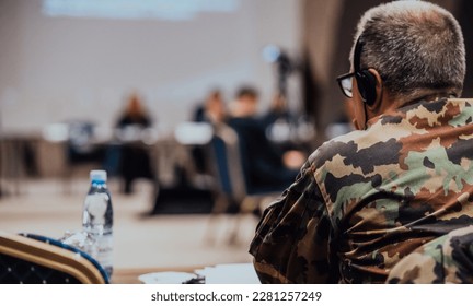 Photo of a soldier leading a seminar for professional training of military personnel - Powered by Shutterstock