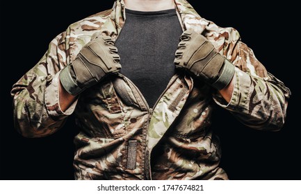 Photo Of A Soldier In Multicam Camouflage Tunic On Black Background.