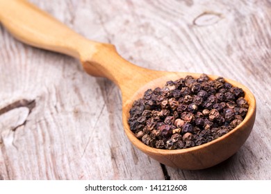  photo of Spoon with pepper on vintage wooden table with black background - Powered by Shutterstock
