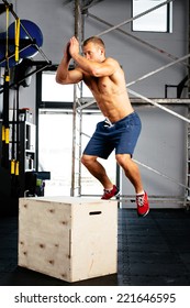 Photo of a sportsman working out his body in box jumping