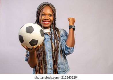 Photo of sporty attractive lady raise thumb fingers up advising cool way earn money sports bet hold leather ball wear football uniform t-shirt shorts isolated white color background