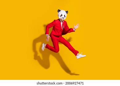 Photo Of Sporty Energetic Panda Guy Jump Run Wear Mask Red Tux Shoes Isolated On Yellow Color Background