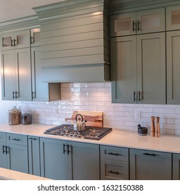 Photo Square Wooden Cabinets And White Counter Top Inside A Kitchen With Tile Backsplash