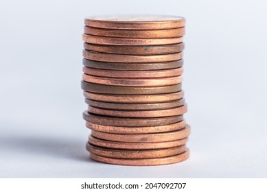 Photo of a stack of pennies on a white background - Shutterstock ID 2047092707