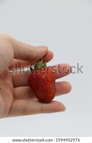 photo of strawberry fruit in hand