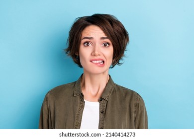 Photo Of Stressed Young Bob Hairdo Lady Bite Lip Wear Khaki Shirt Isolated On Blue Color Background