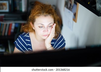 Photo Of A Stressed Young Woman Working Late On A Computer