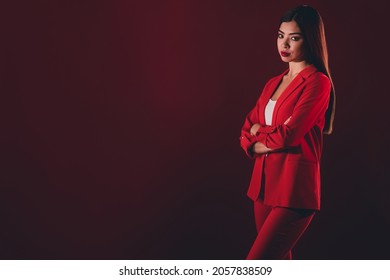 Photo Of Strict Manager Millennial Brunette Lady Croosed Arms Wear Red Suit Isolated On Dark Color Background