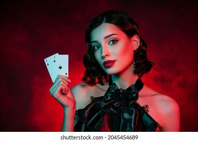 Photo of stunning elegant stylish young woman hold hands ace cards poker player isolated on neon filter background