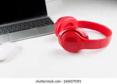 Photo Of Stylish Modern Computer Or Notebook And Red Headphones Over White Background. Trendy Office, Freelance Workplace.