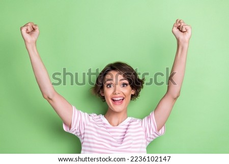 Photo of success millennial lady yell wear white striped t-shirt isolated on green color background