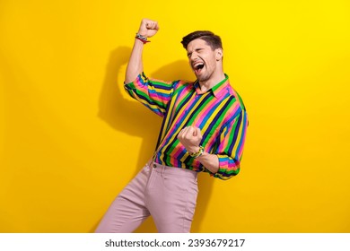 Photo of successful businessman raised fists up shouting enjoying his perfection champion in dancing isolated on yellow color background - Powered by Shutterstock