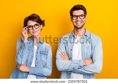 Photo of successful cheerful people best friends confident family team wear stylish jeans outfit isolated on yellow color background