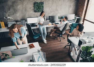 Photo of successful young happy people office workers discuss project workspace indoors - Powered by Shutterstock